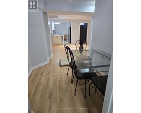 A dining room with a glass table and chairs.