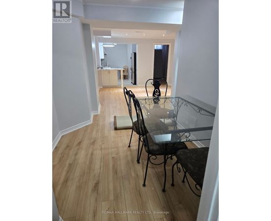 A dining room with a glass table and chairs.