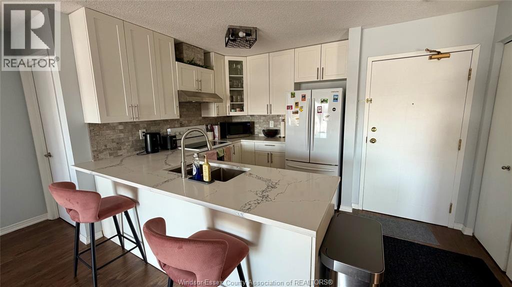 A kitchen with a white countertop and a sink.