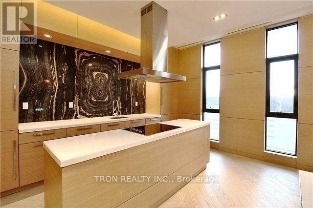 A modern kitchen with wooden cabinets and a large island.