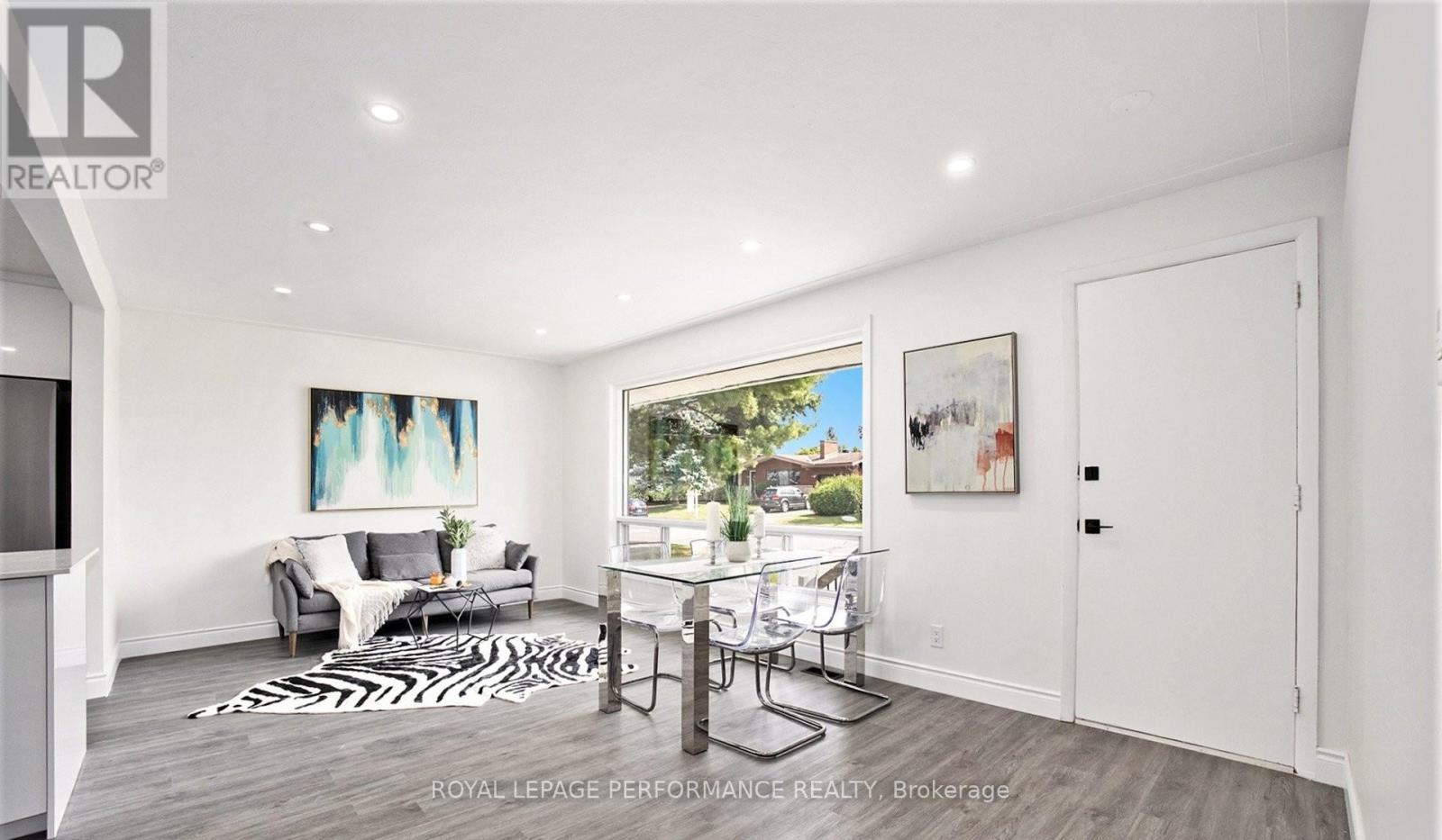 A living room with a white couch and a zebra print rug.