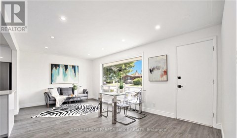 A living room with a white couch and a zebra print rug.