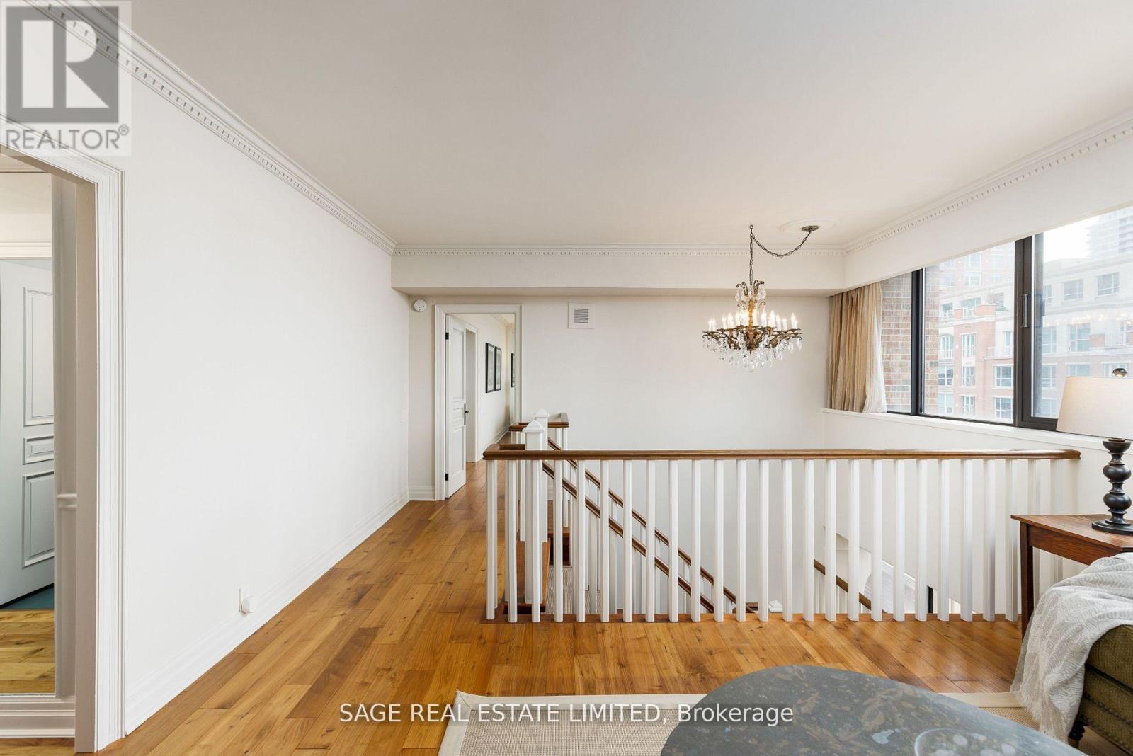 A well-lit, spacious room with a staircase leading to the second floor.