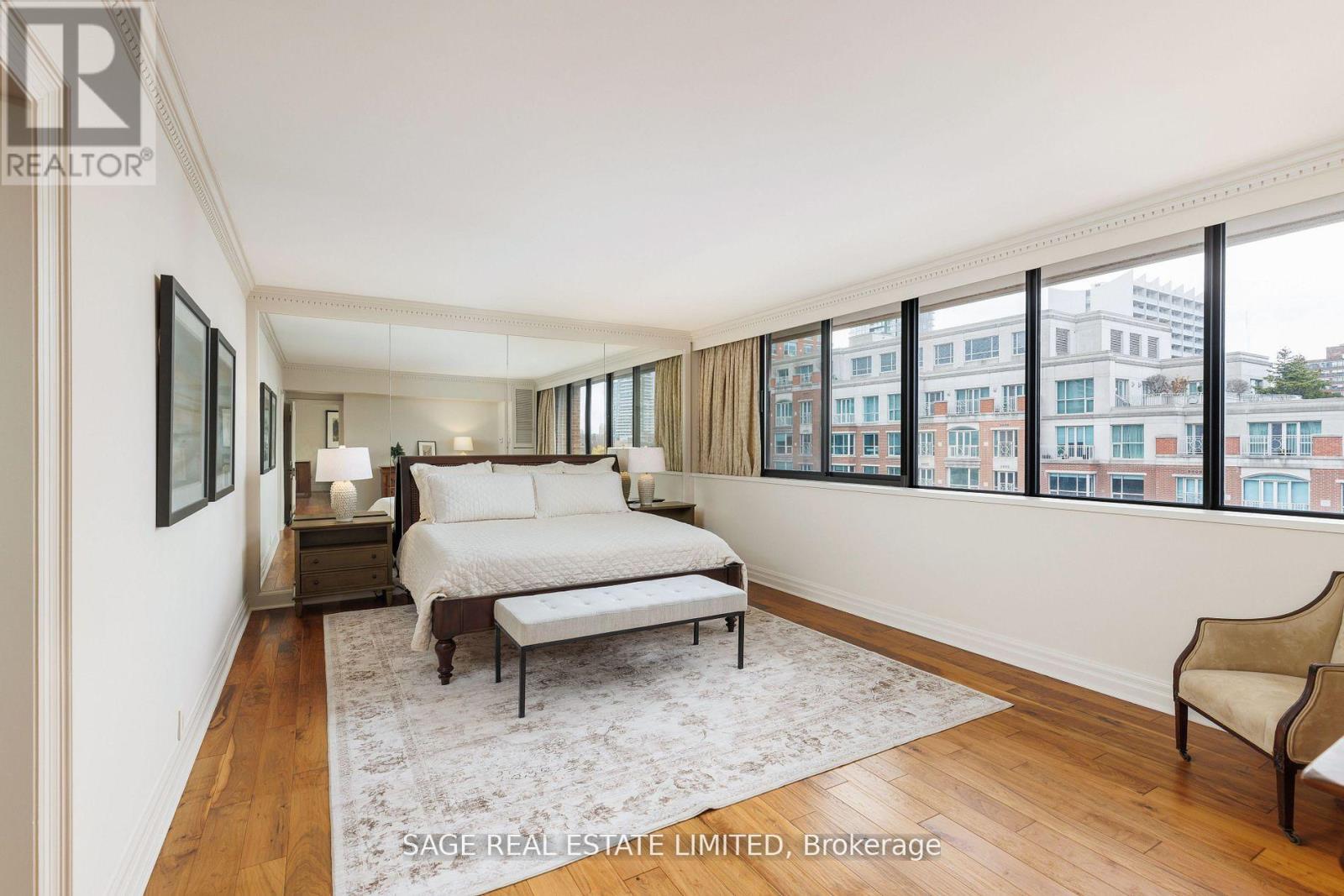 A bedroom with a large bed and a view of the city.