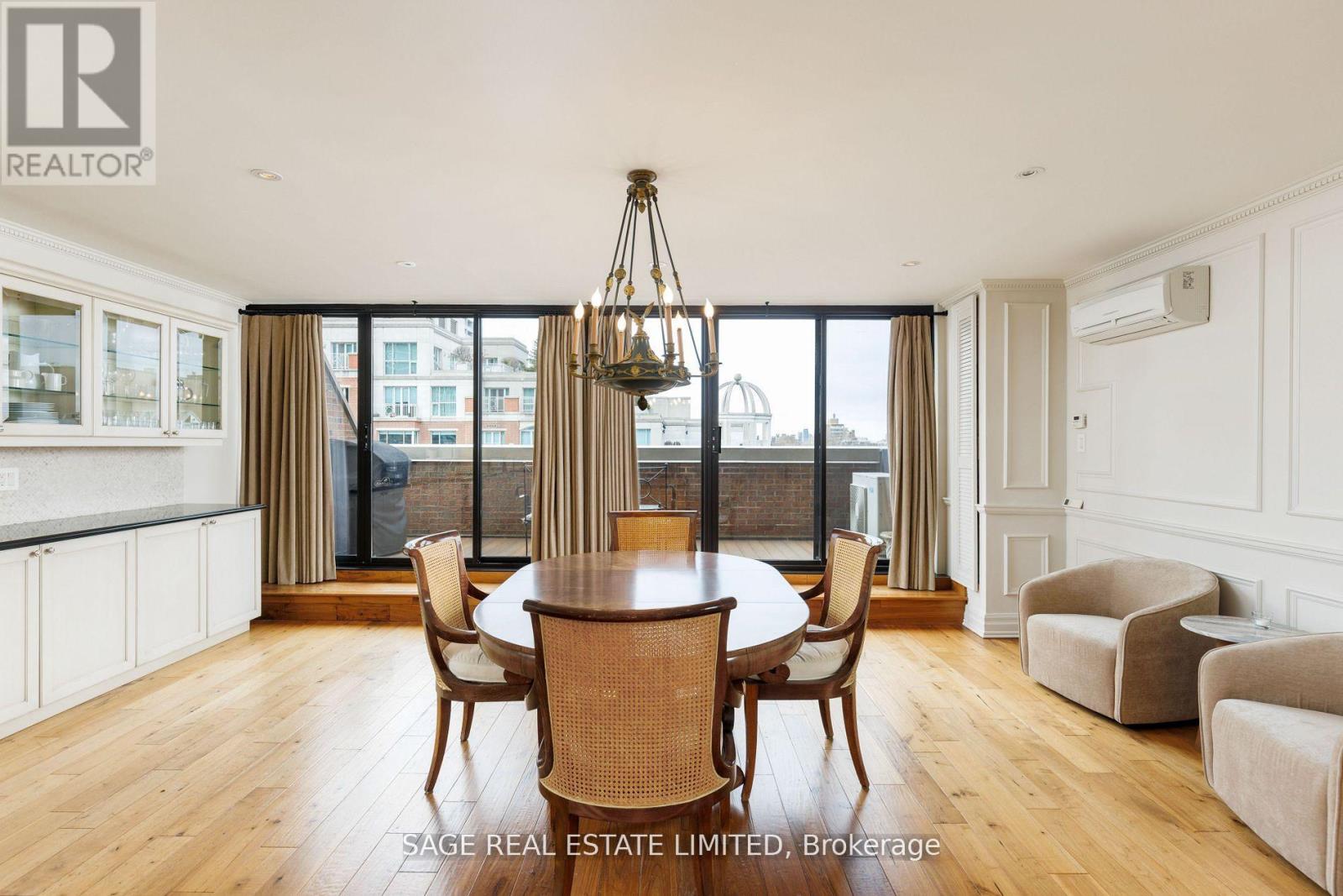 A dining room with a wooden table and chairs.