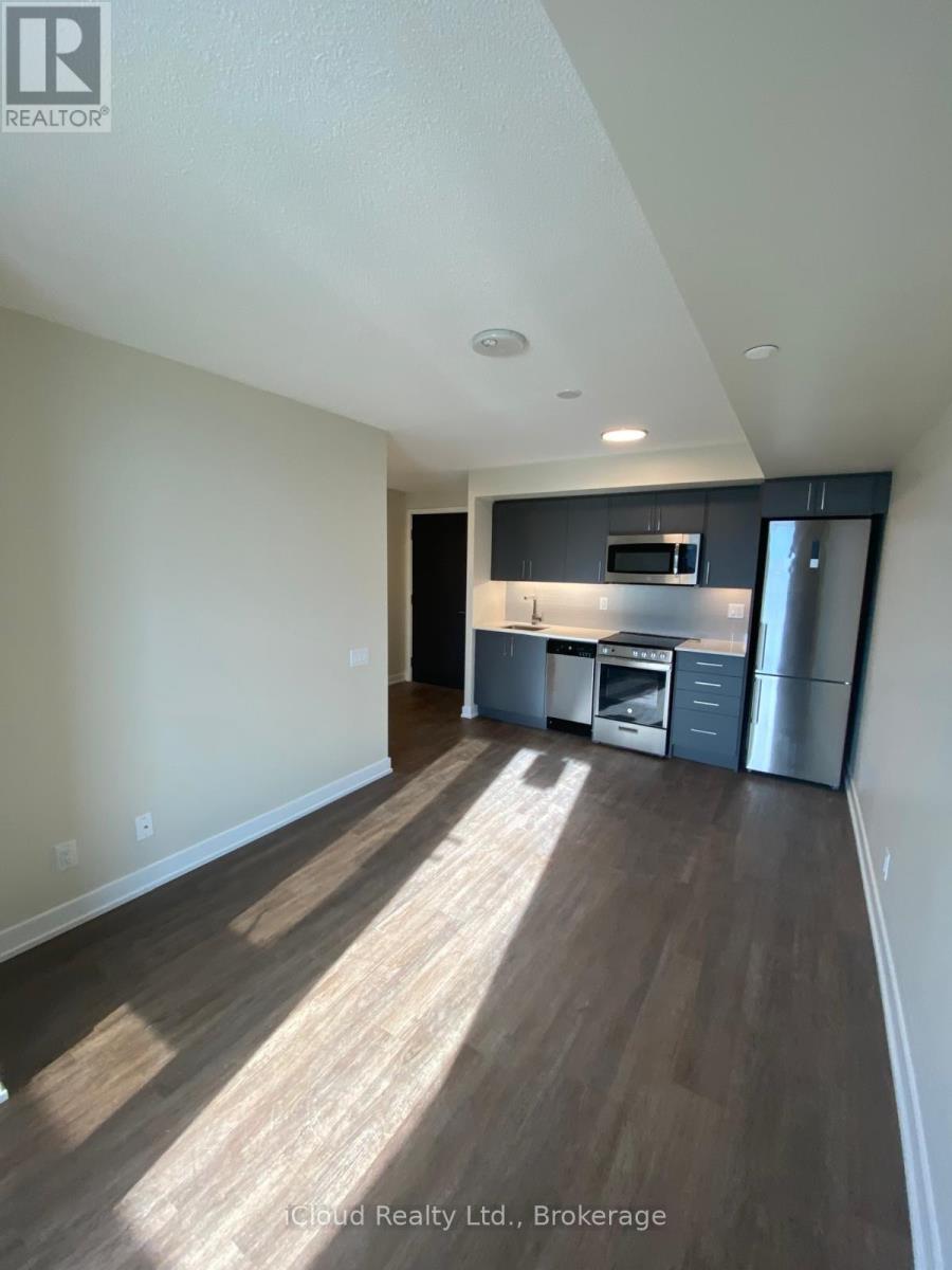 A well-lit kitchen area with wooden flooring and modern appliances.