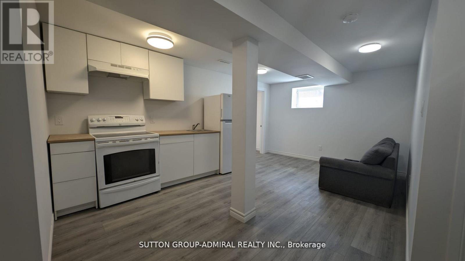 A kitchen with white cabinets and a stove top oven.