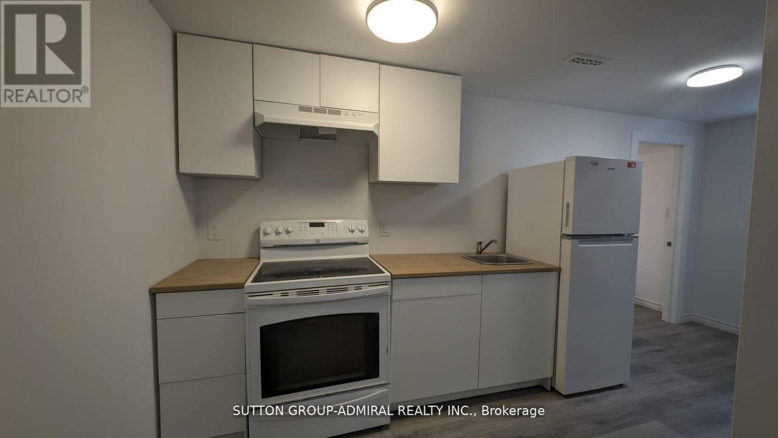 A kitchen with a stove, oven, and refrigerator.