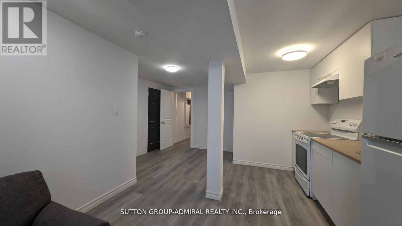 A kitchen area with a refrigerator, microwave, and oven.