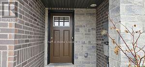 A brown door is at the end of a hallway.