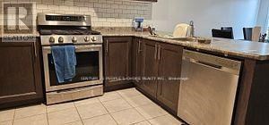 A kitchen with a stove and a dishwasher.