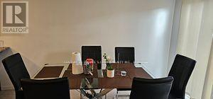 A conference room with a table and chairs and a sign that says REALTOR.
