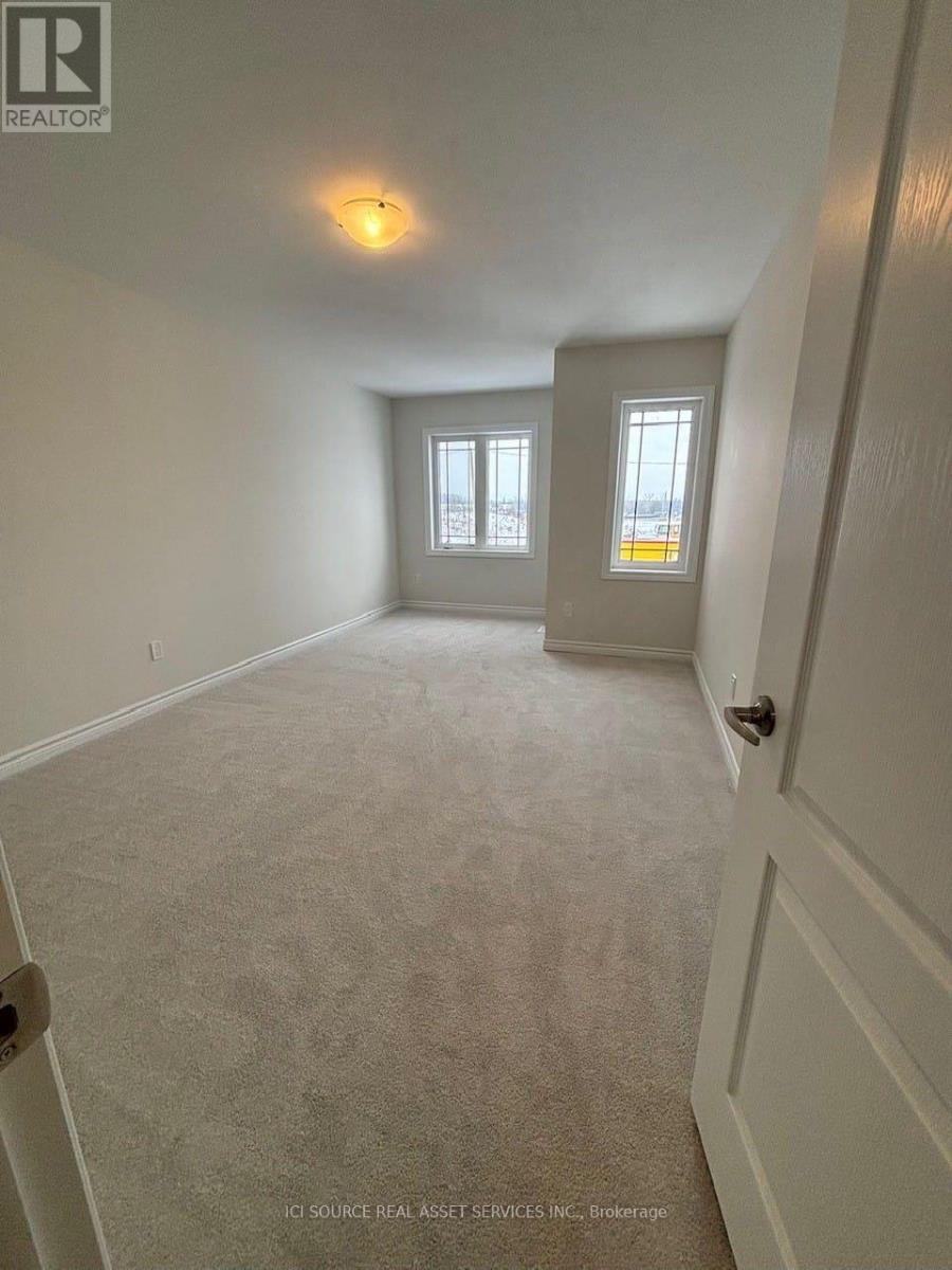 A room with a carpeted floor and a door on the right side.