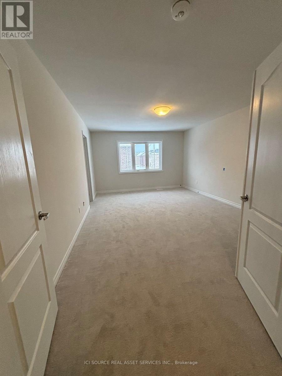 A long hallway with white walls and carpeting.