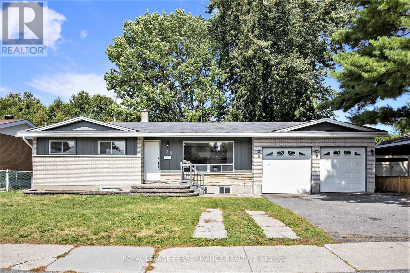 A two-story house with a garage is for sale.