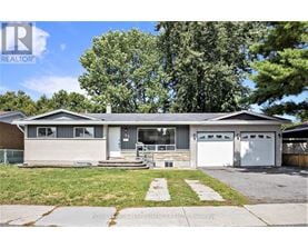A two-story house with a garage is for sale.
