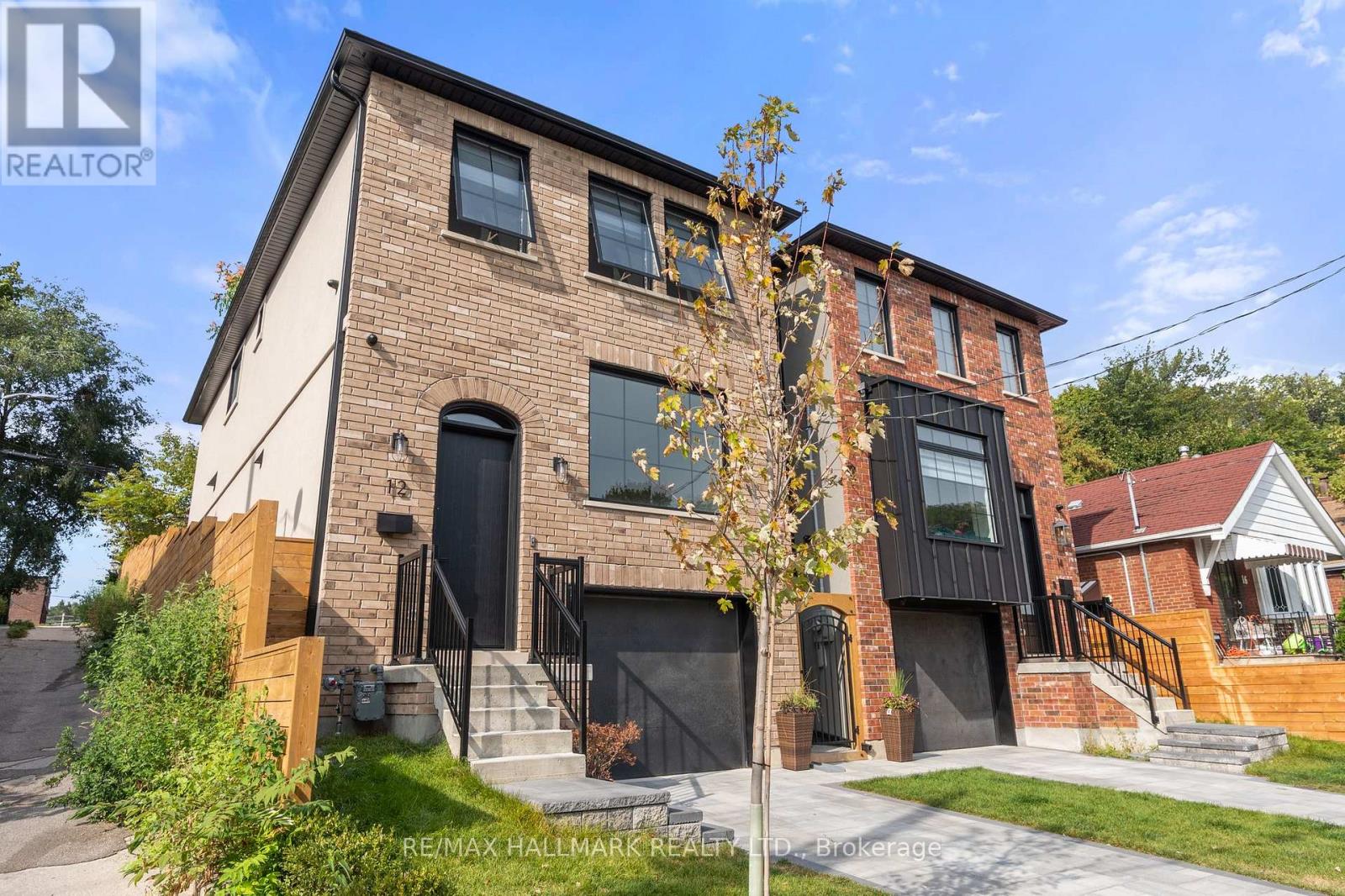 A brick house with a black door and windows.