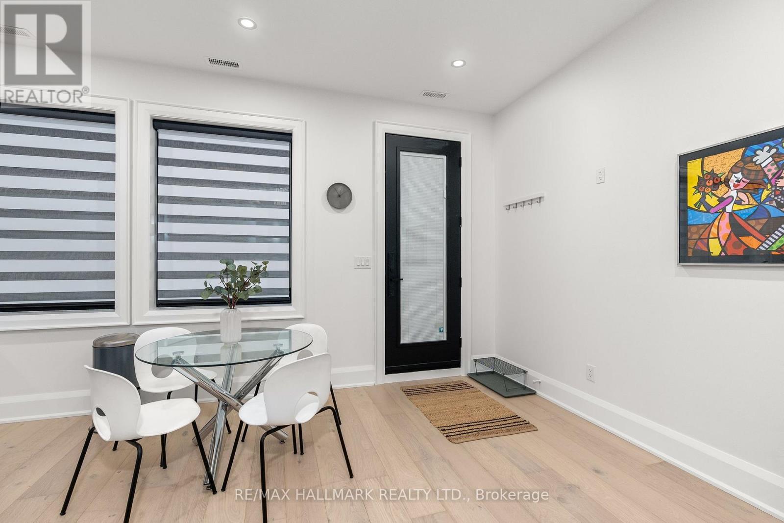 A dining room with a glass table and chairs.
