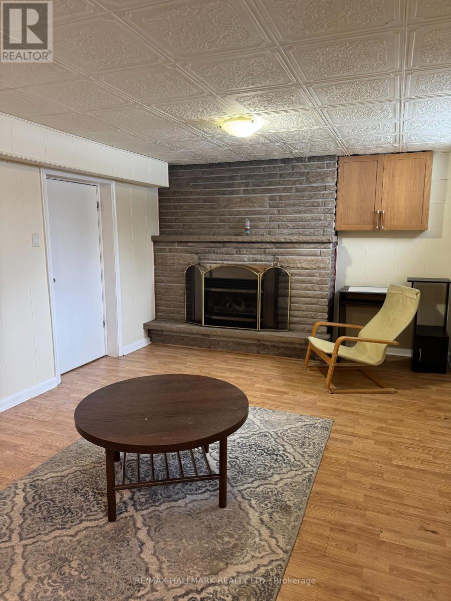 A living room with a fireplace and a chair.