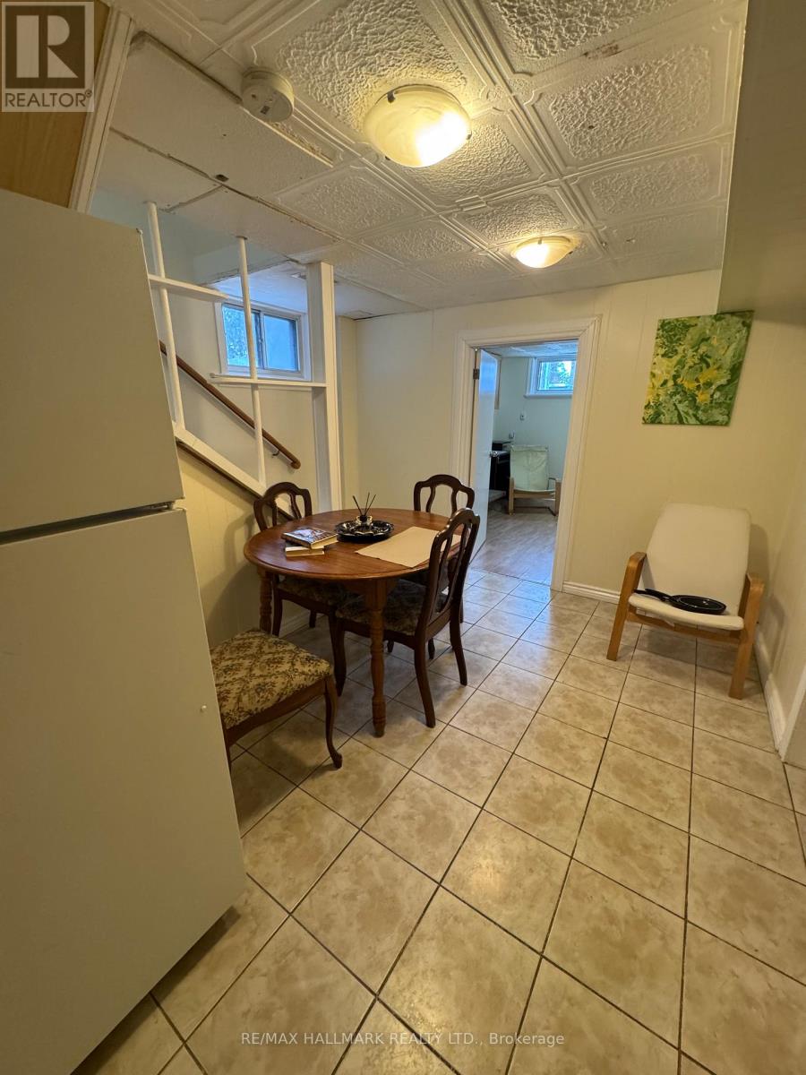 A dining room with a table and chairs.