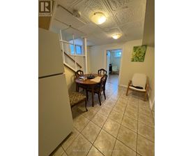 A dining room with a table and chairs.