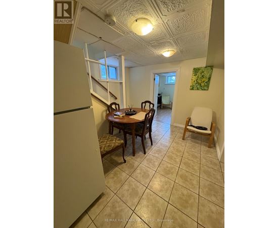 A dining room with a table and chairs.