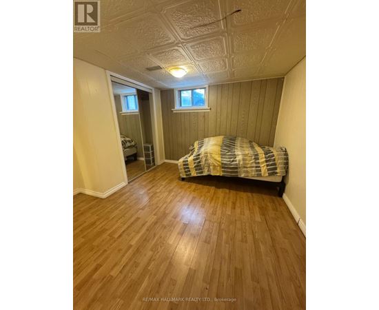 A bedroom with a bed and a window.