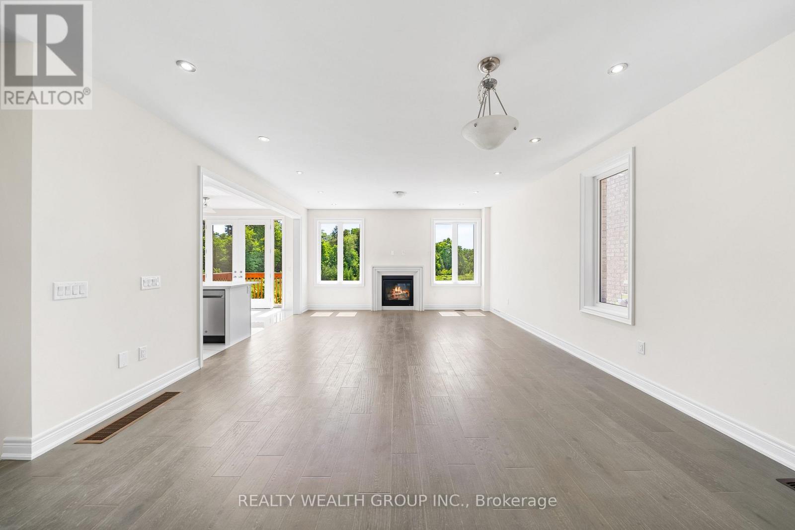 A spacious room with a fireplace and a painting on the wall.