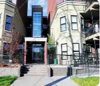 A building with a black gate and a white door.
