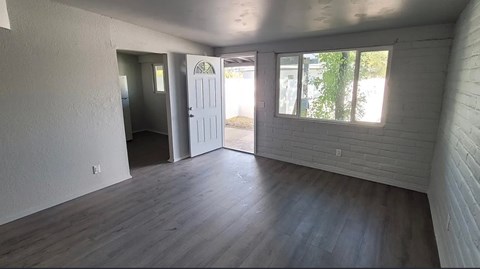 A room with a white door and a window.