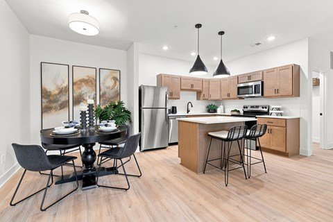A modern kitchen with a dining table and chairs.