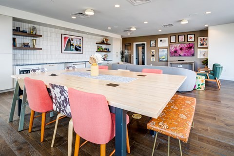 A dining room with a long table and chairs.