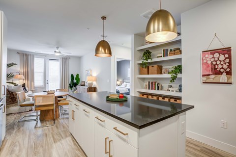 A modern kitchen with a dining table and chairs.