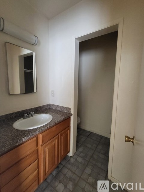 A bathroom with a sink and mirror.