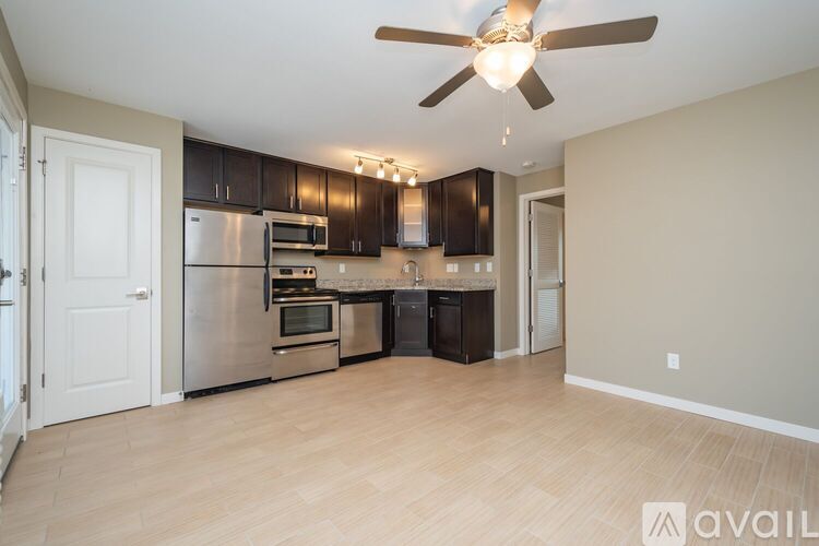 A kitchen with a refrigerator, oven, and microwave.