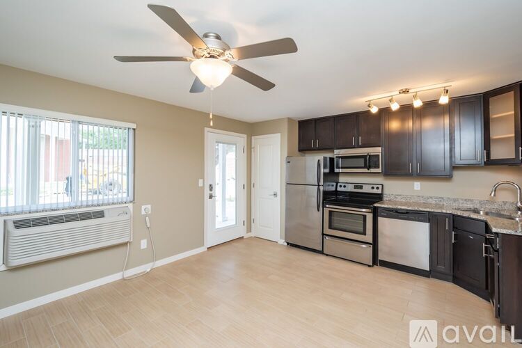 A kitchen with a fan and a microwave.