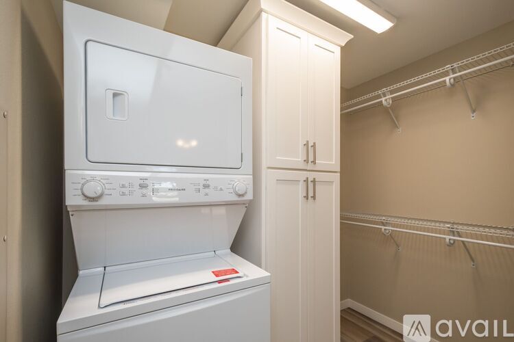 A white dryer and washer in a small laundry room.