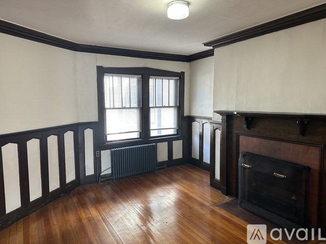 A room with a fireplace and a window.