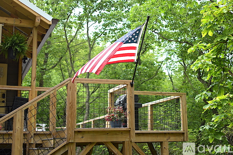 A wooden deck with a flag on top.