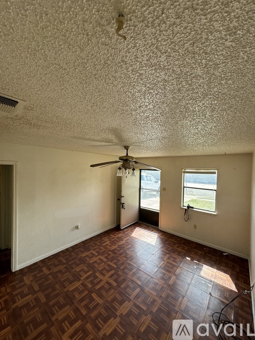 A room with a ceiling fan and a window.