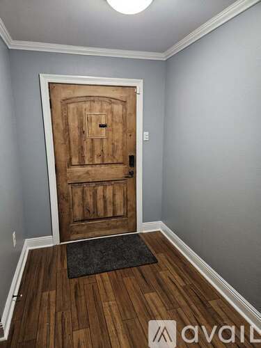A wooden door with a mat in front of it.
