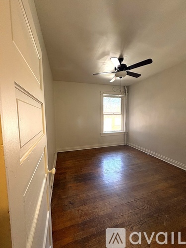 A room with a wooden floor and a white door.