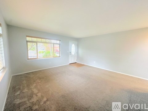 A staircase with a carpeted floor and a couch in the background.