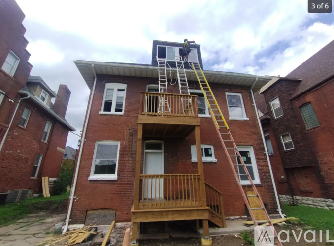 A house with a ladder on the roof.