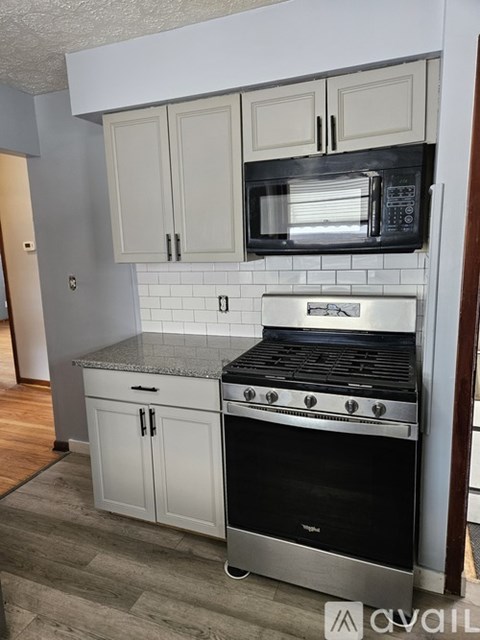 A kitchen with a stove top oven and microwave.