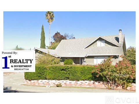 A house with a sign that says "Powered By: 1st REALTY & INVESTMENT BRE01477184".
