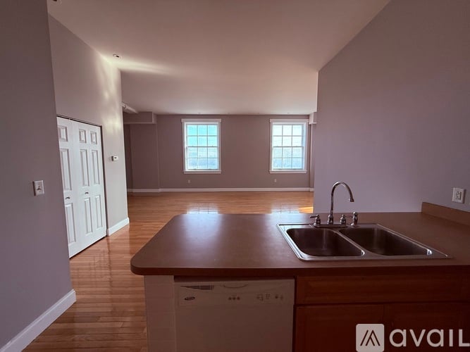 A kitchen with a sink and a dishwasher.