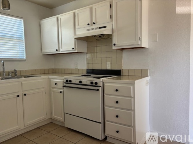 A room with tiled flooring and a ceiling fan.