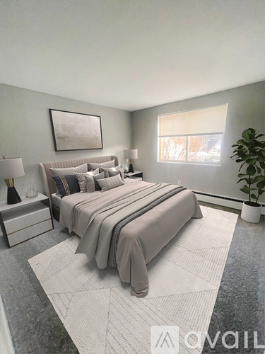 A bedroom with a large bed and a plant.