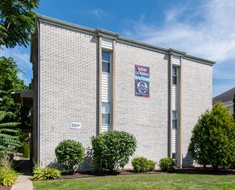 a white brick building with a sign on the side of it